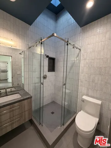 a bathroom with a shower a toilet and a sink