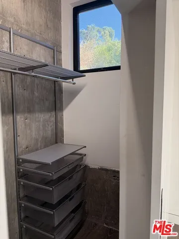 a view of a big room with wooden floor and windows