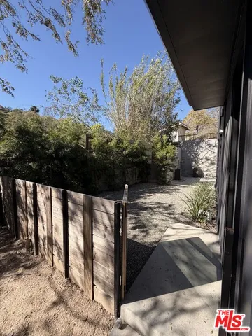 a view of a backyard with a tree