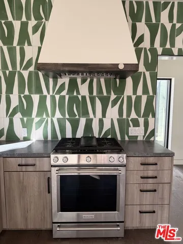 a stove top oven sitting inside of a kitchen
