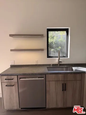 a kitchen with a sink and a window