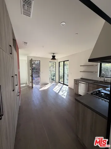a kitchen with stainless steel appliances a refrigerator and a stove