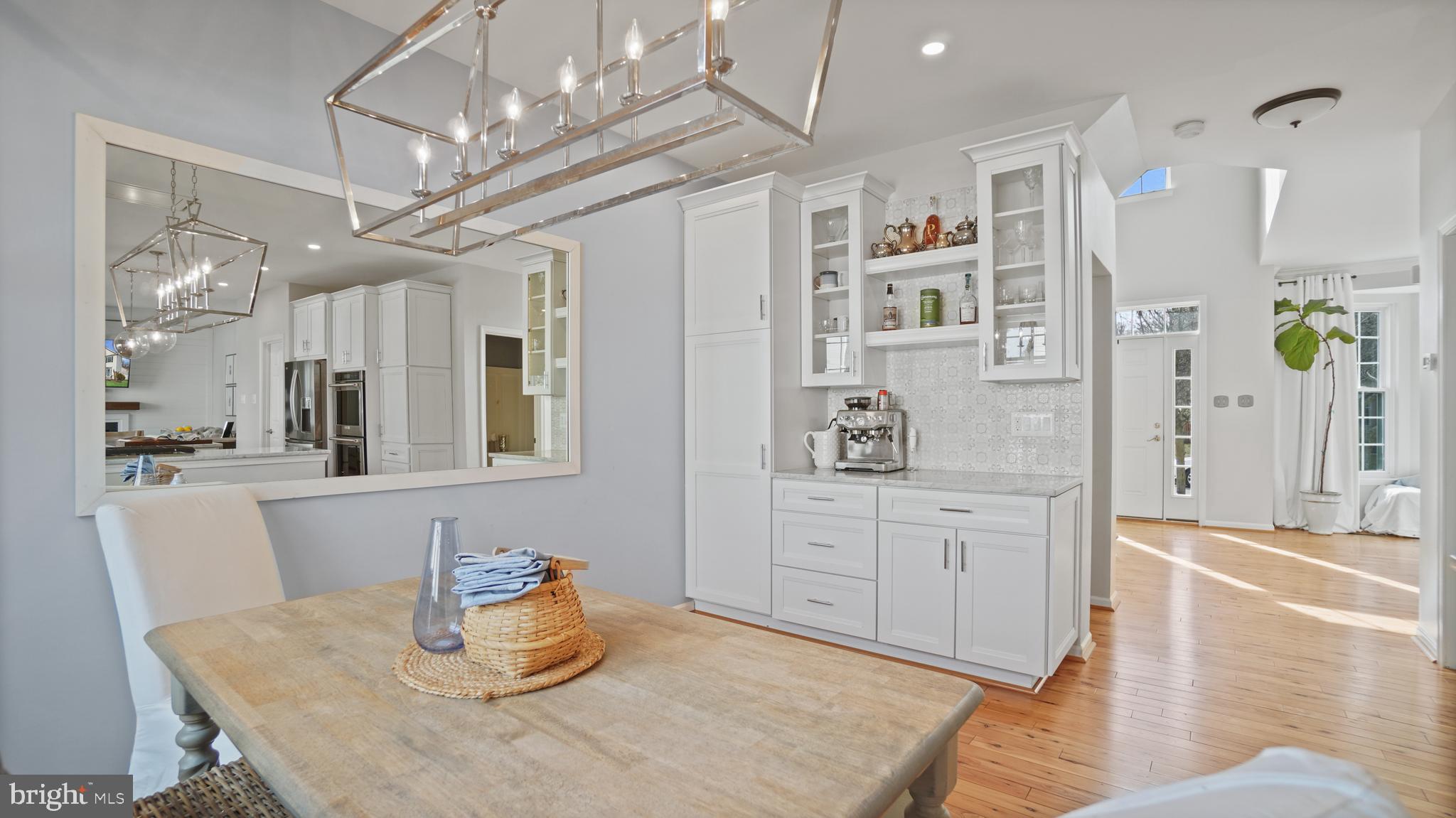 2801 Elsa Court Crofton, MD 21054 - Photo 13 of 58 a kitchen with stainless steel appliances kitchen island granite countertop a table chairs in it and wooden floors