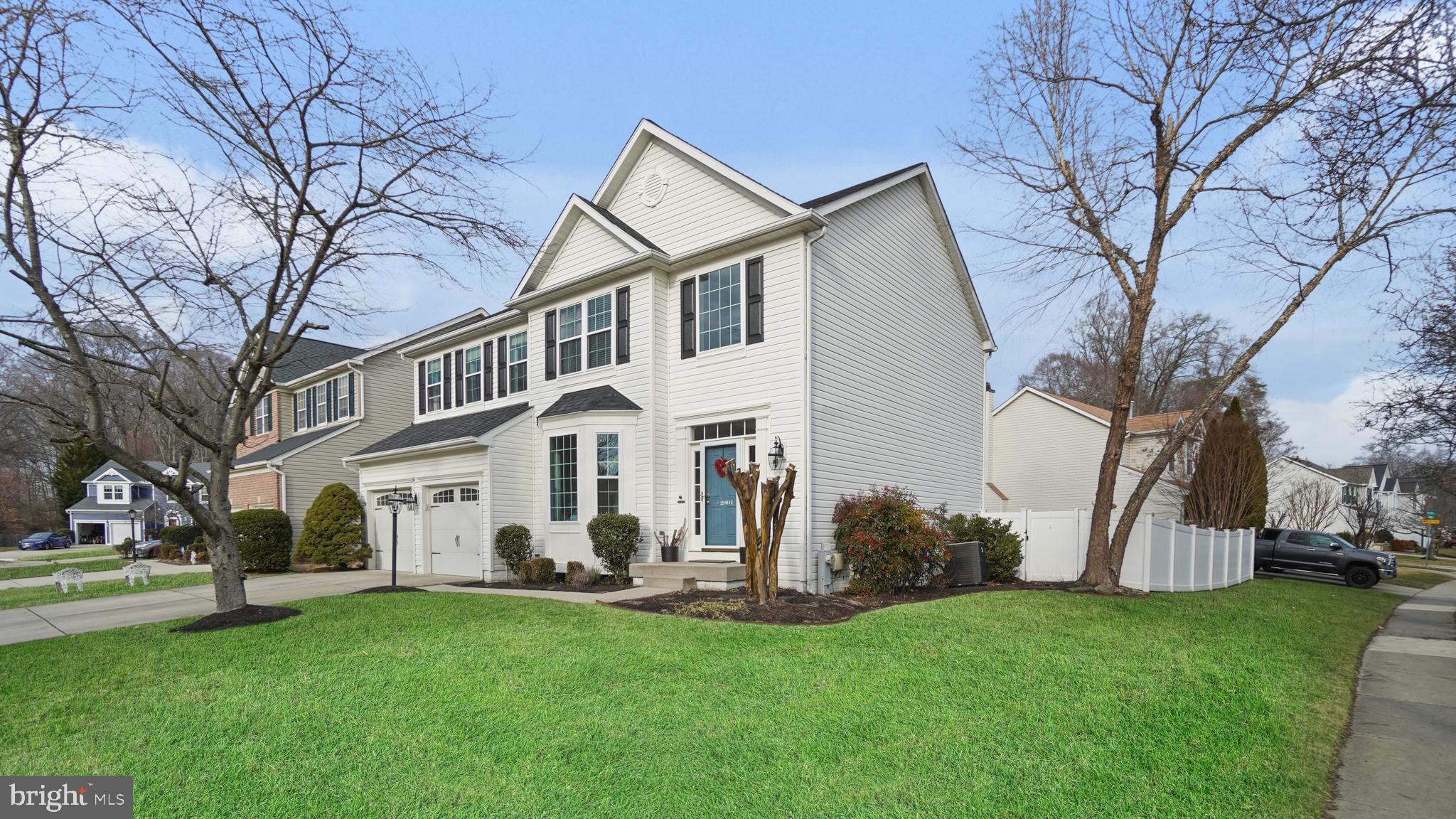 2801 Elsa Court Crofton, MD 21054 - Photo 2 of 58 a view of a white house next to a yard and large trees