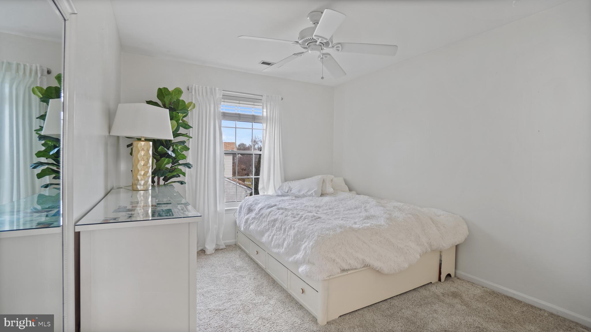 2801 Elsa Court Crofton, MD 21054 - Photo 36 of 58 a bedroom with a bed chandelier and a window