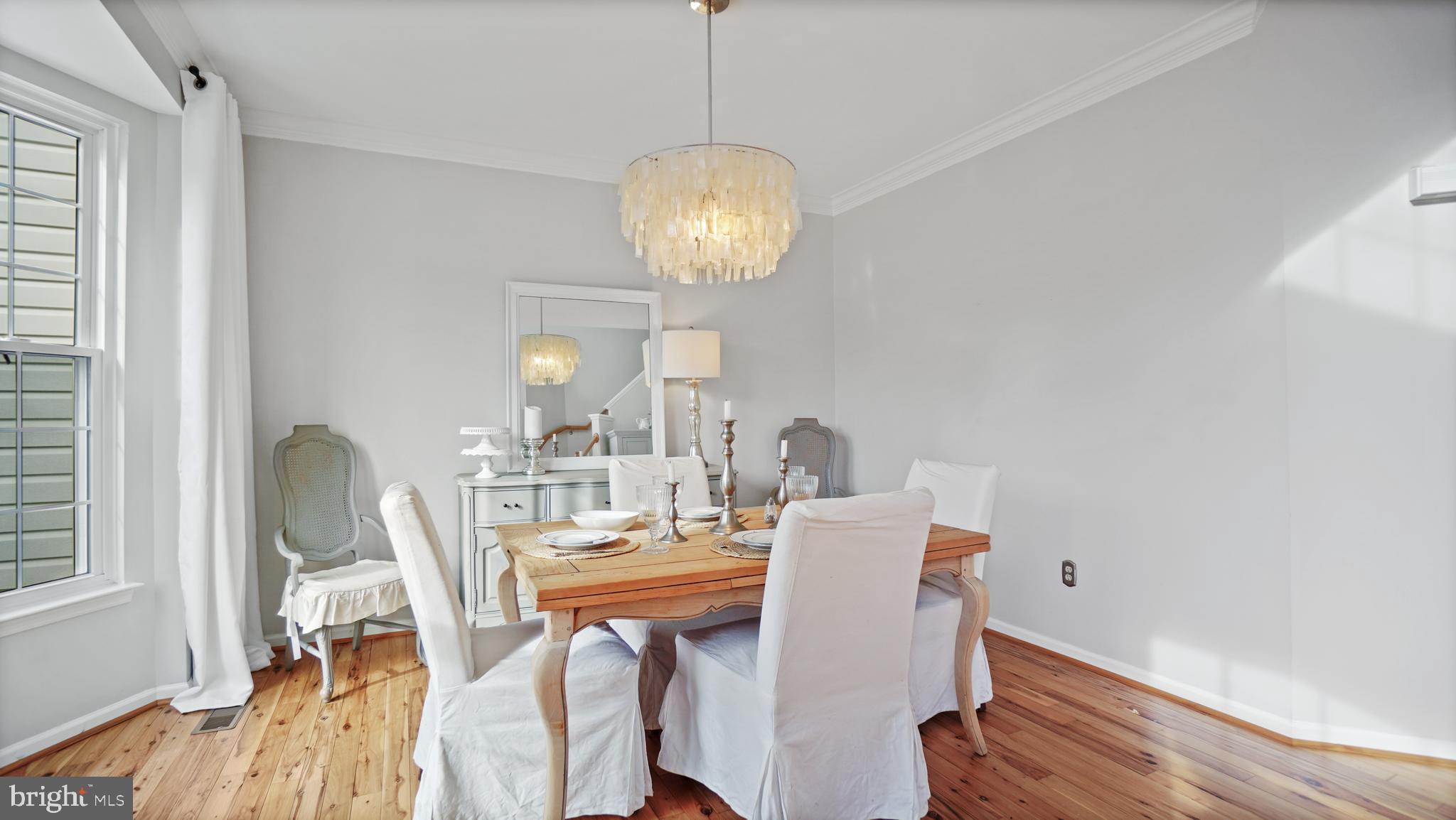 2801 Elsa Court Crofton, MD 21054 - Photo 4 of 58 a view of a dining room with furniture a chandelier and wooden floor
