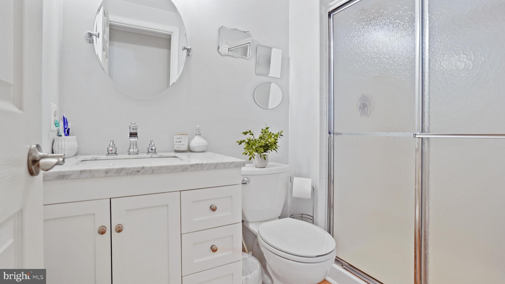 2801 Elsa Court Crofton, MD 21054 - Photo 48 of 58 a bathroom with a granite countertop sink toilet and a mirror