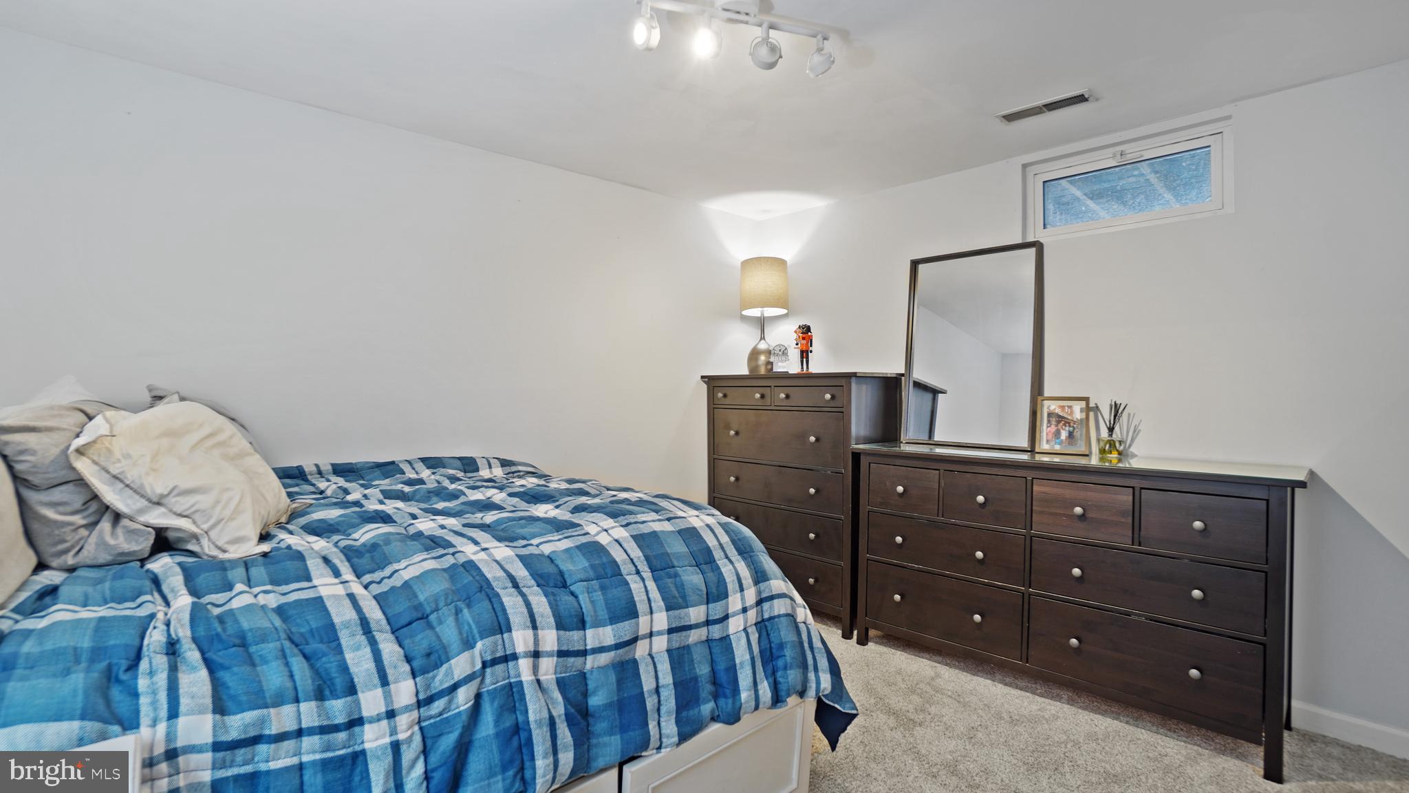 2801 Elsa Court Crofton, MD 21054 - Photo 50 of 58 a bedroom with a bed and a mirror