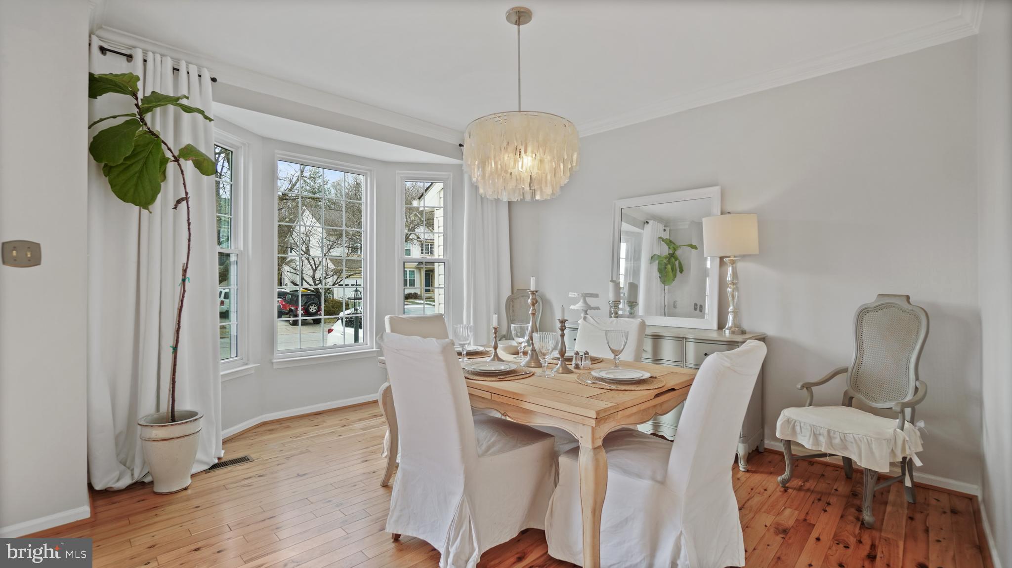 2801 Elsa Court Crofton, MD 21054 - Photo 6 of 58 a dining room with furniture a chandelier and wooden floor