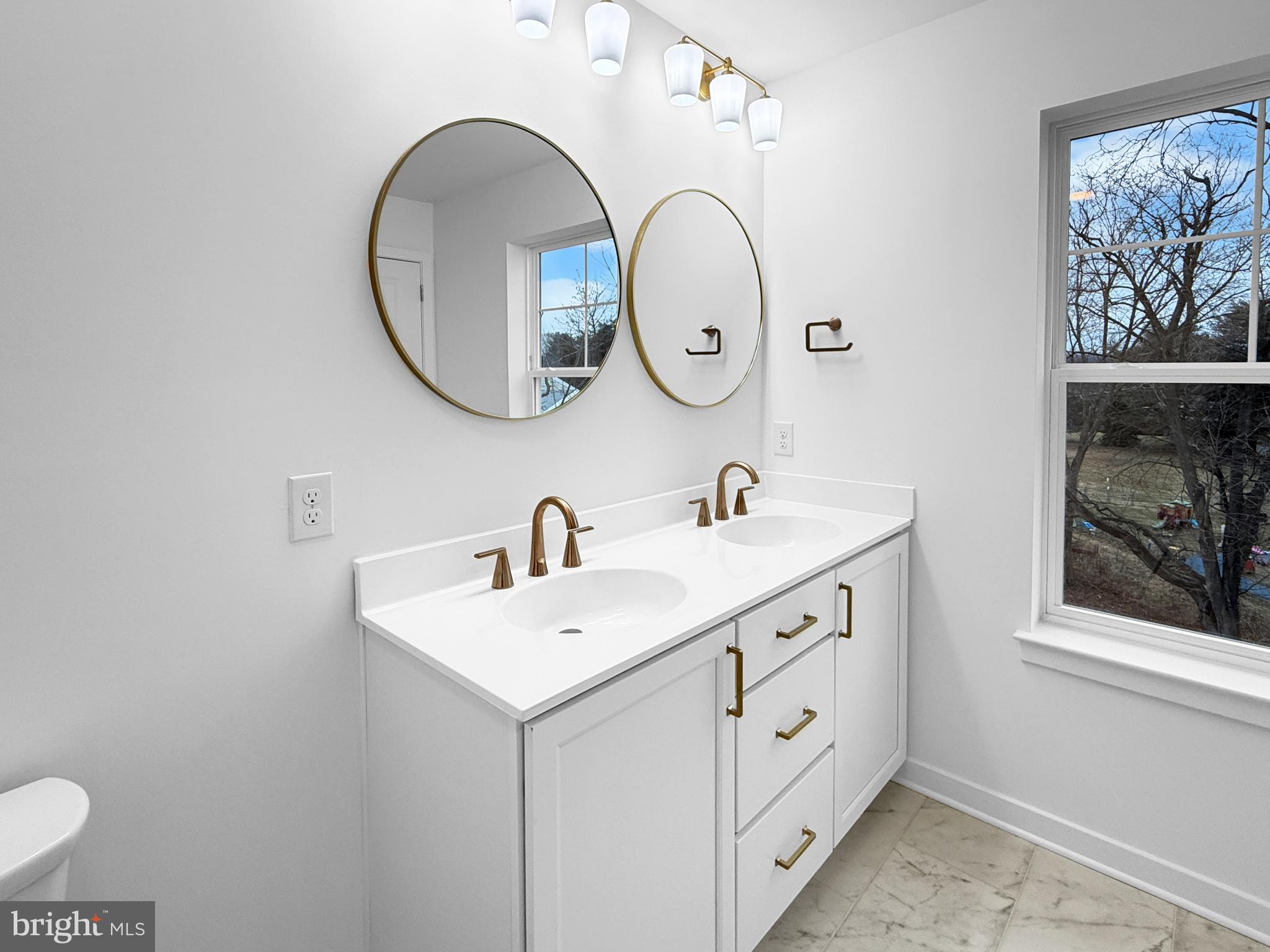 11 West Butler Avenue New Britain, PA 18901 - Photo 37 of 42 a bathroom with a sink and a mirror