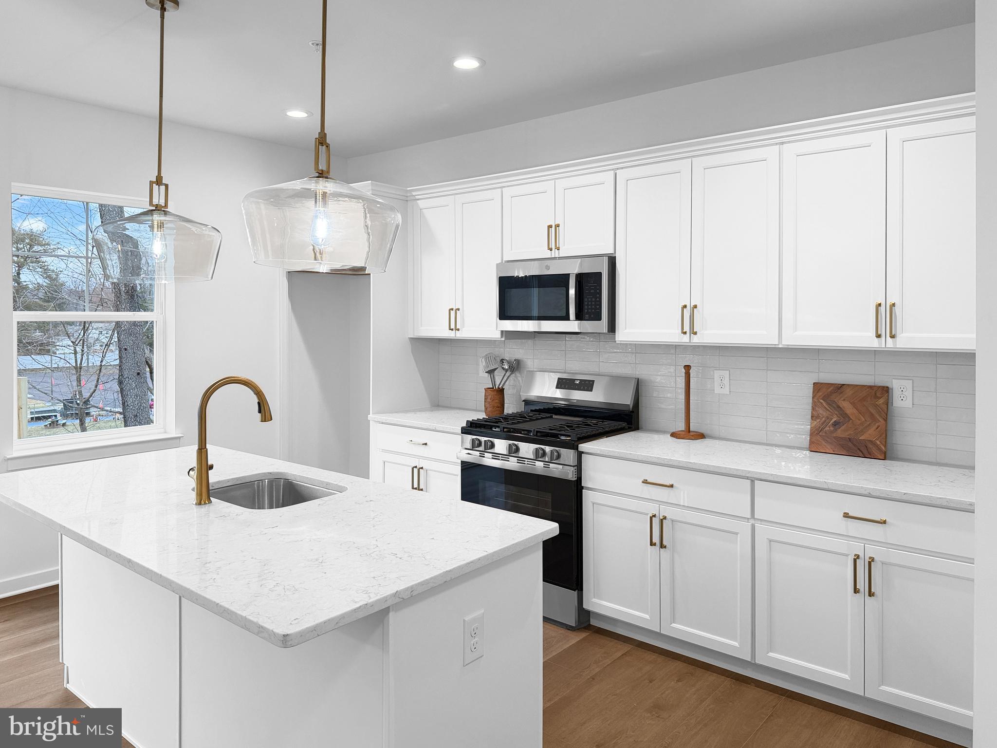 11 West Butler Avenue New Britain, PA 18901 - Photo 10 of 42 a kitchen with kitchen island granite countertop a sink stainless steel appliances and white cabinets