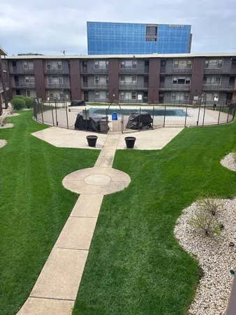 a view of a house with backyard sitting area and fire pit