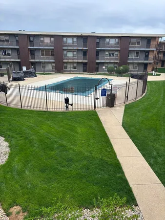 a view of a house with a yard and sitting area