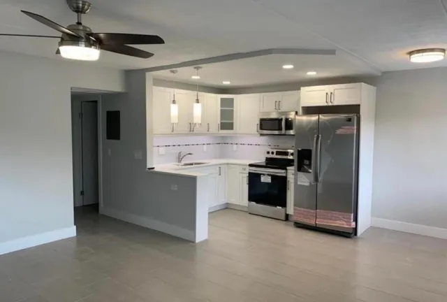 a kitchen with a refrigerator and a stove