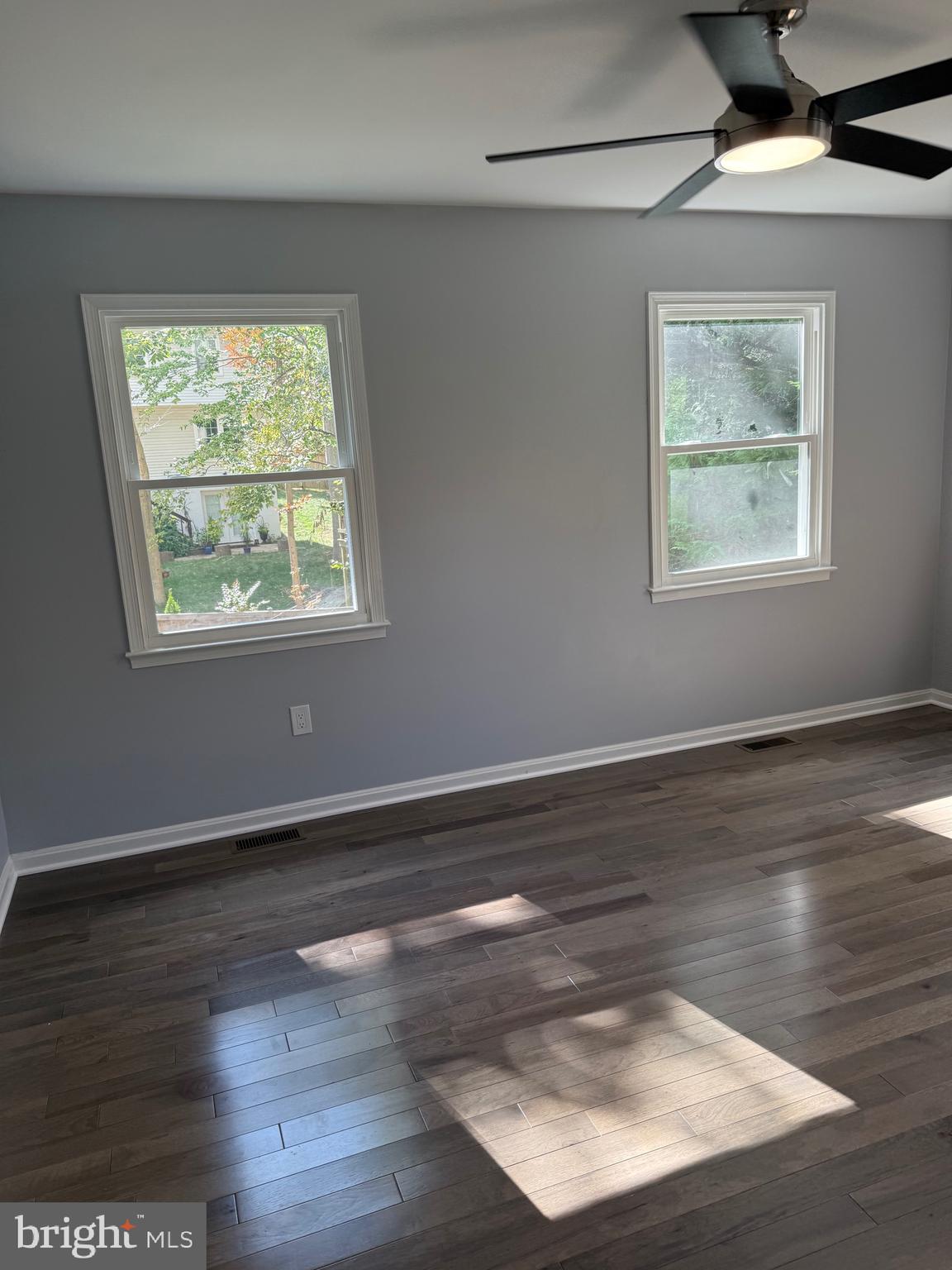 7810 Newington Woods Drive Springfield, VA 22153 - Photo 13 of 50 a view of an empty room with wooden floor and a window