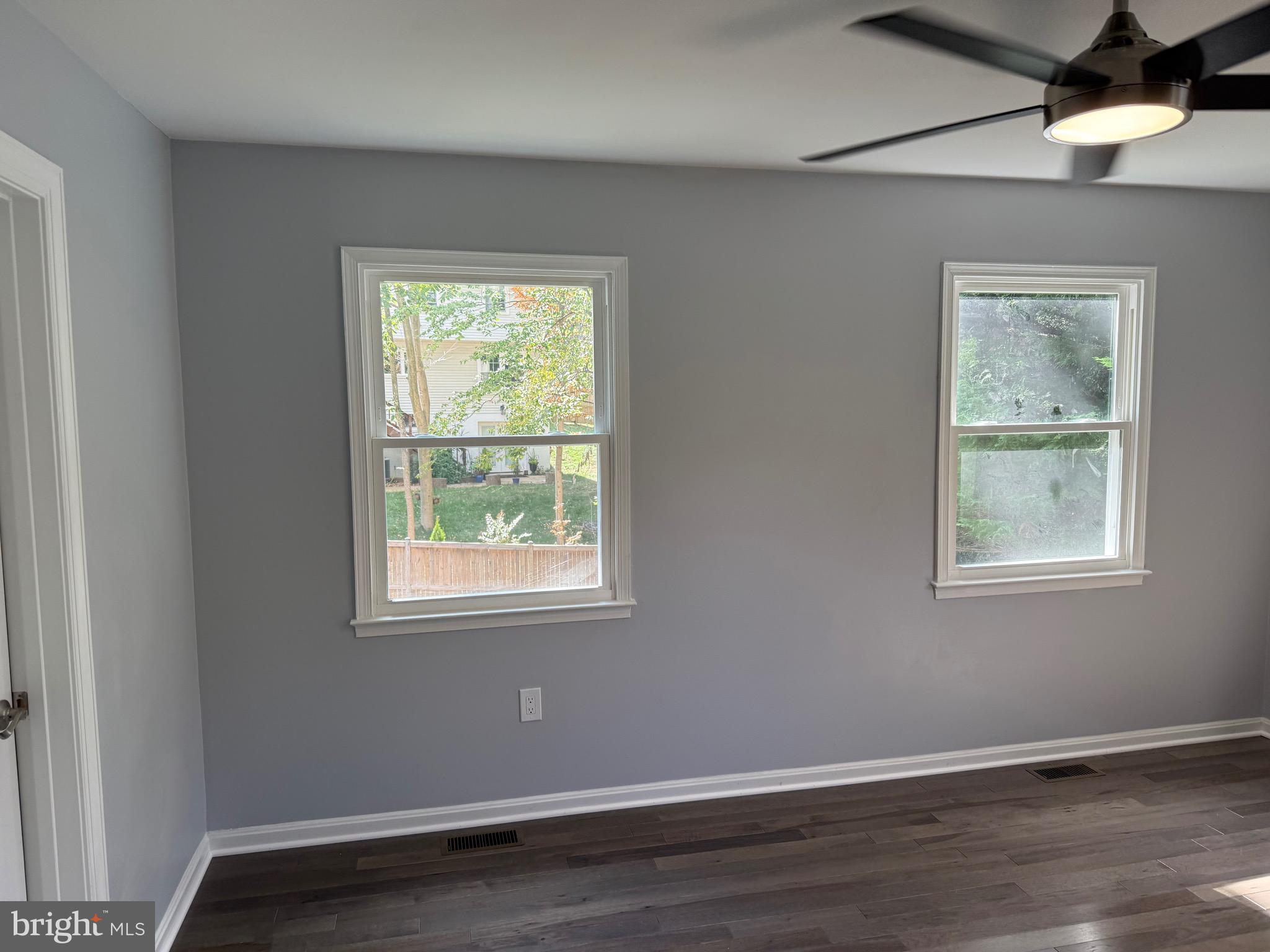 7810 Newington Woods Drive Springfield, VA 22153 - Photo 14 of 50 a view of an empty room with wooden floor and a window