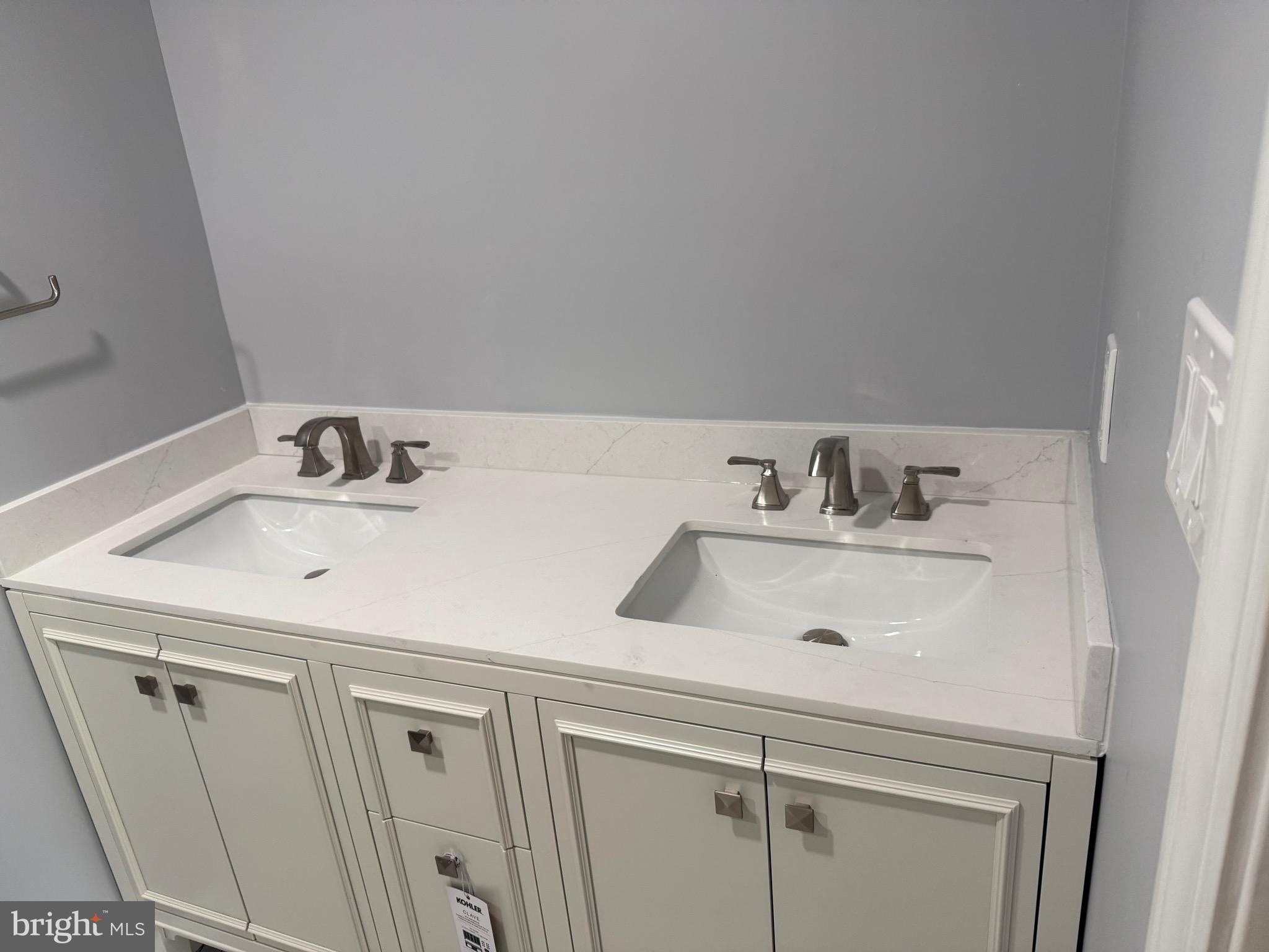 7810 Newington Woods Drive Springfield, VA 22153 - Photo 16 of 50 a bathroom with a sink and a washing machine