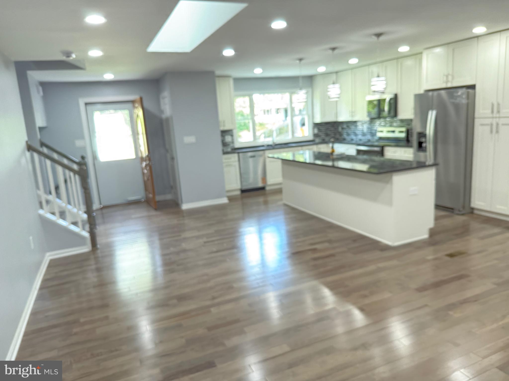 7810 Newington Woods Drive Springfield, VA 22153 - Photo 2 of 50 a kitchen with stainless steel appliances granite countertop a refrigerator a sink dishwasher and a stove with wooden floor
