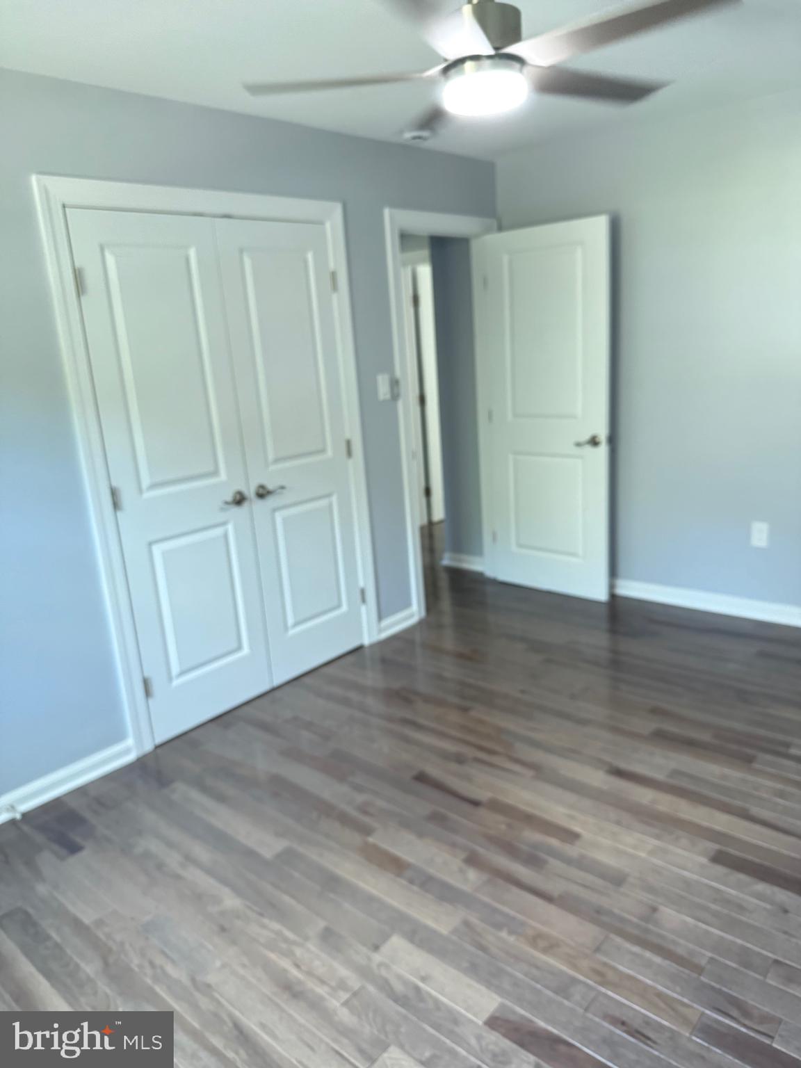 7810 Newington Woods Drive Springfield, VA 22153 - Photo 25 of 50 an empty room with wooden floor and cabinet