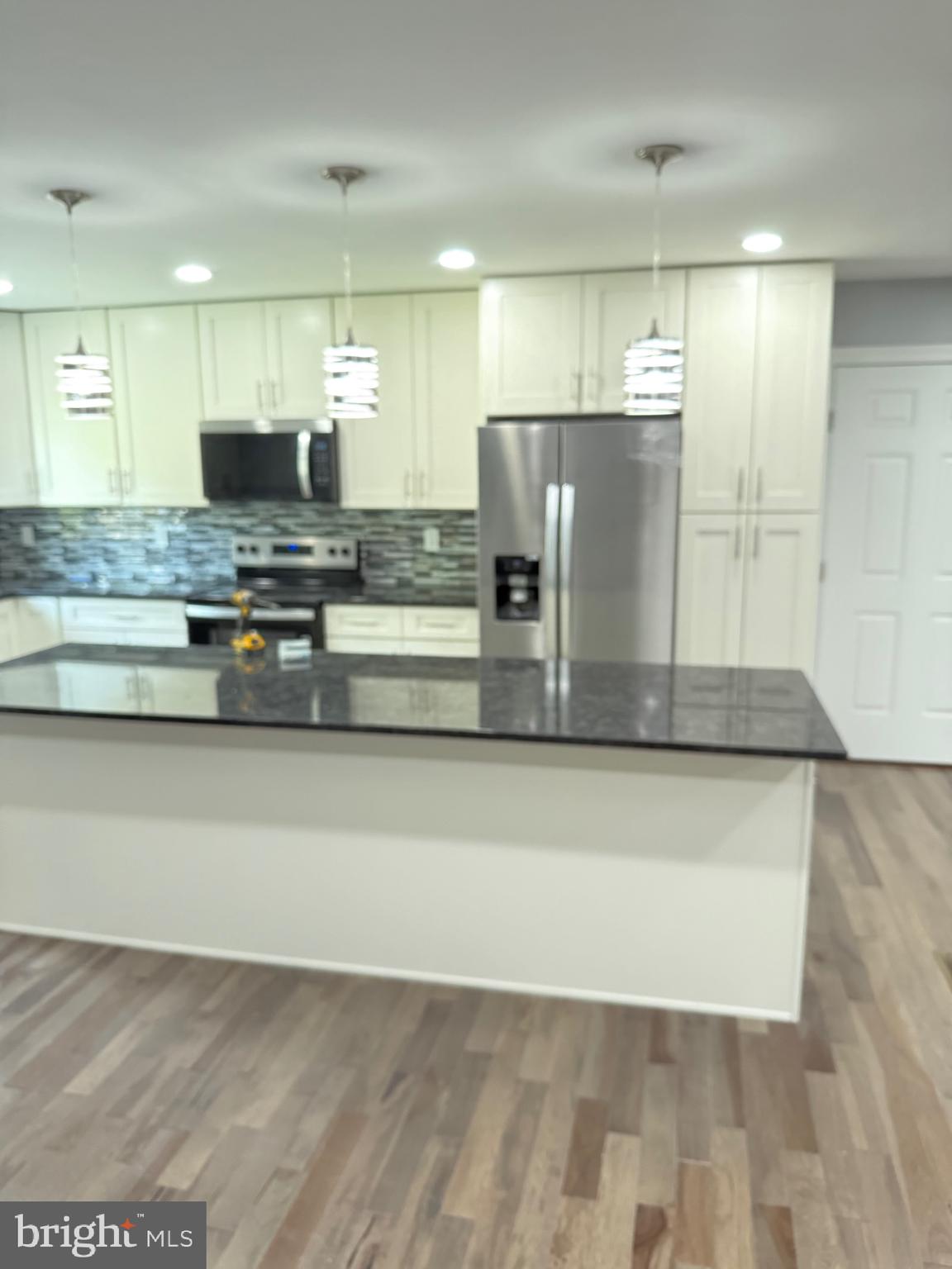 7810 Newington Woods Drive Springfield, VA 22153 - Photo 32 of 50 a view of a kitchen with stainless steel appliances granite countertop a refrigerator a stove and a sink