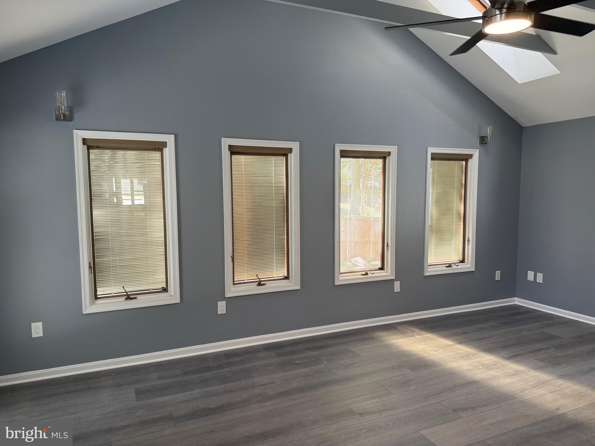 7810 Newington Woods Drive Springfield, VA 22153 - Photo 33 of 50 an empty room with wooden floor and windows