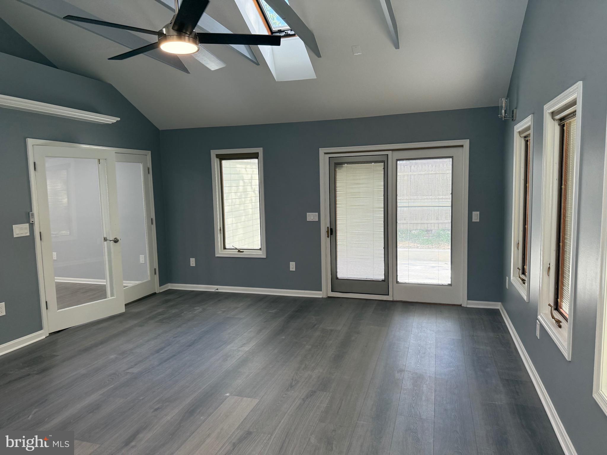 7810 Newington Woods Drive Springfield, VA 22153 - Photo 37 of 50 an empty room with wooden floor fan and windows