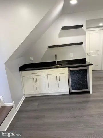 a kitchen with granite countertop a stove and a sink