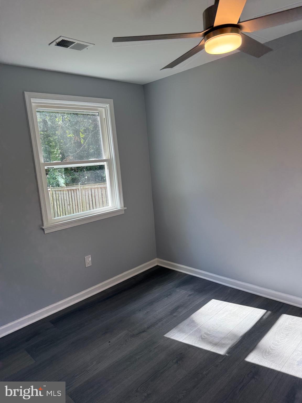 7810 Newington Woods Drive Springfield, VA 22153 - Photo 48 of 50 a view of empty room with wooden floor and fan