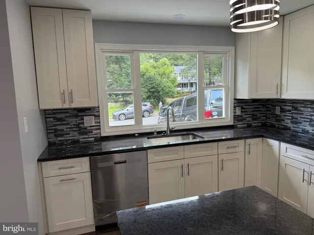 a kitchen with granite countertop a sink and a window