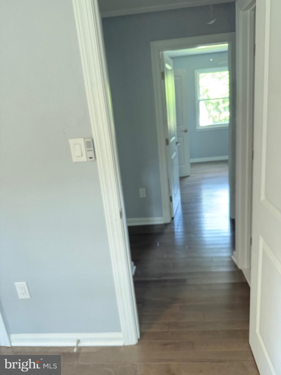 7810 Newington Woods Drive Springfield, VA 22153 - Photo 9 of 50 a view of a hallway with wooden floor and staircase