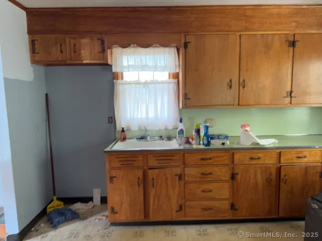 a room with wooden cabinets and clock on the wall