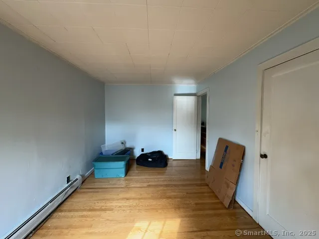 a room with a bed and a mirror