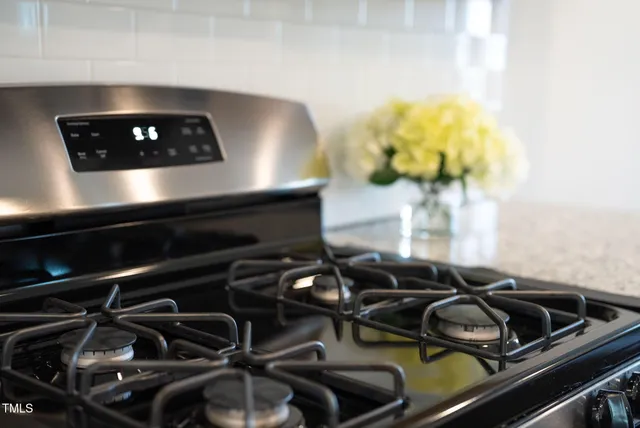 a kitchen with center island a sink stainless steel appliances and living room view