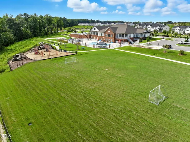 an aerial view of a house with garden space and street view