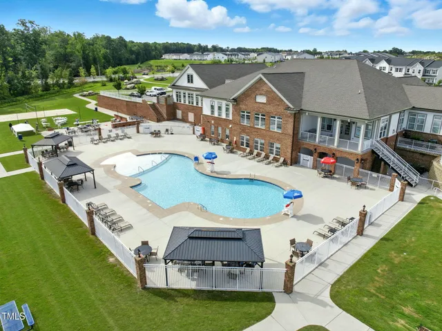 a room with a table chairs and a flat screen tv