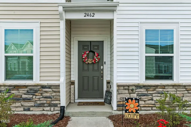 a front view of a house with garden