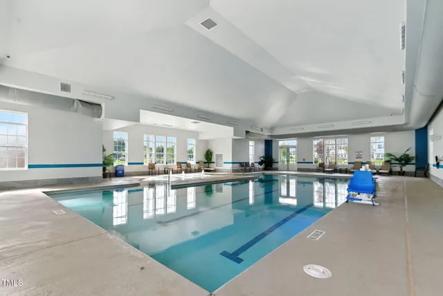 a living room with furniture a flat screen tv and a table