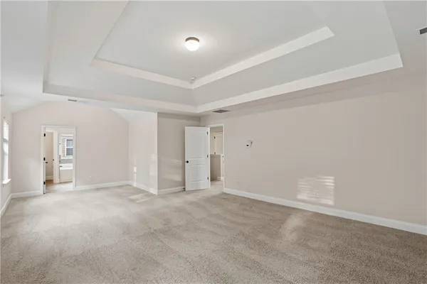 an empty room with windows and entrance to other room