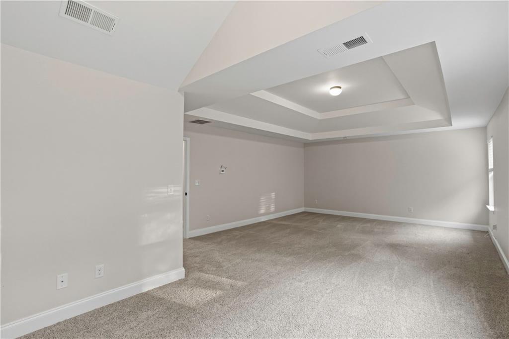 1423 Stone Ridge Court Hampton, GA 30228 - Photo 16 of 22 an empty room with windows and entrance to other room