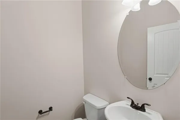 a bathroom with a tub sink vanity and mirror