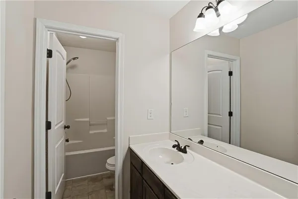 a bathroom with a tub shower and sink