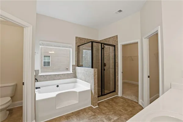 a spacious bathroom with double vanity and a mirror