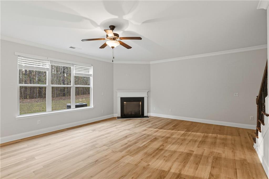 1423 Stone Ridge Court Hampton, GA 30228 - Photo 3 of 22 a view of an empty room with a window and wooden floor