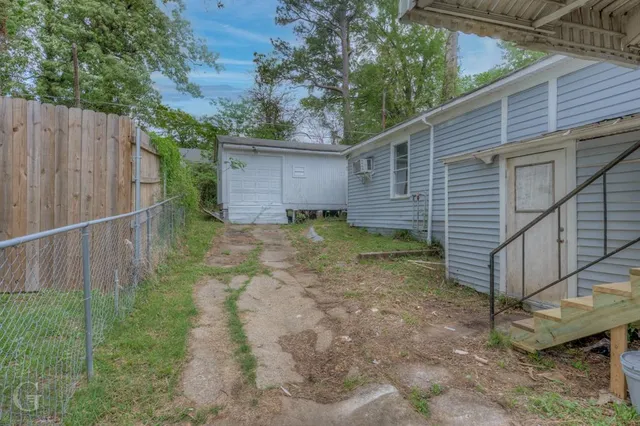 a view of a backyard with wooden fence