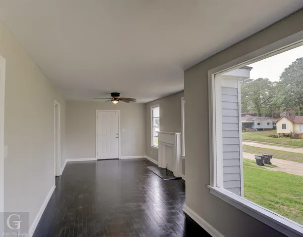 a view of a hardwood floor and a ceiling fan in a room