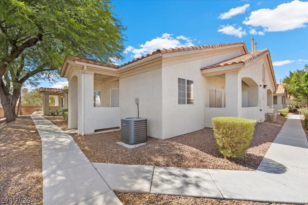 1881 West Alexander Road, Unit 1037 North Las Vegas, NV 89032 - Photo 27 of 31 A well-maintained side exterior offers Mediterranean roof tiles and inviting covered entryways.