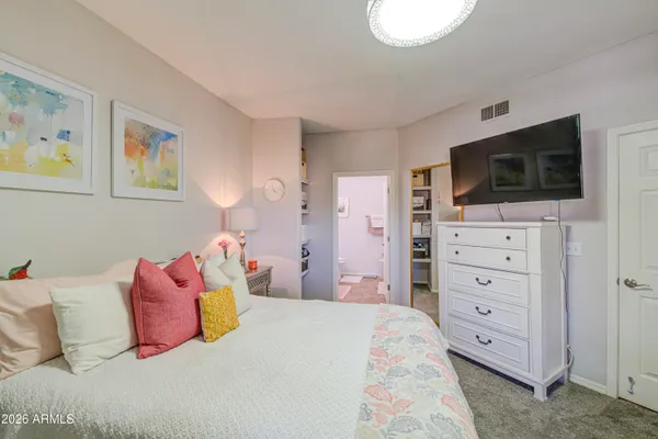 a bedroom with a bed and a flat screen tv