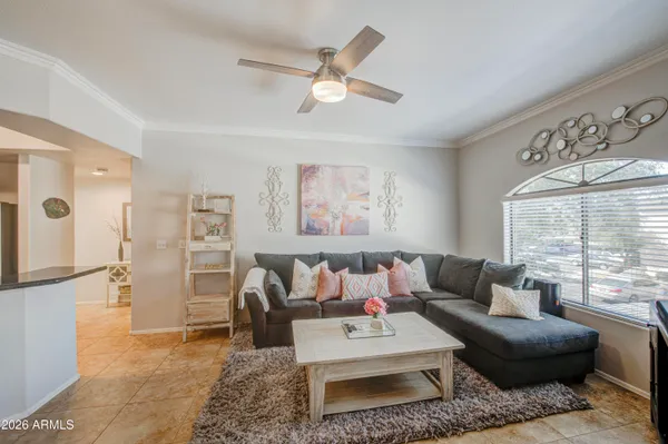a living room with furniture and kitchen view