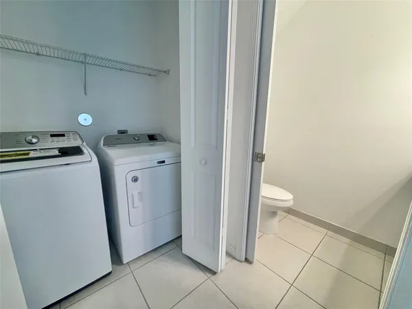a view of a bathroom with a sink and wooden floor