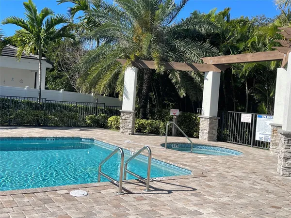 a view of backyard with swimming pool and outdoor seating